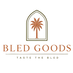 A centered logo on a white background featuring an arched palm tree emblem above the text 'BLED GOODS' and smaller text 'TASTE THE BLED'.